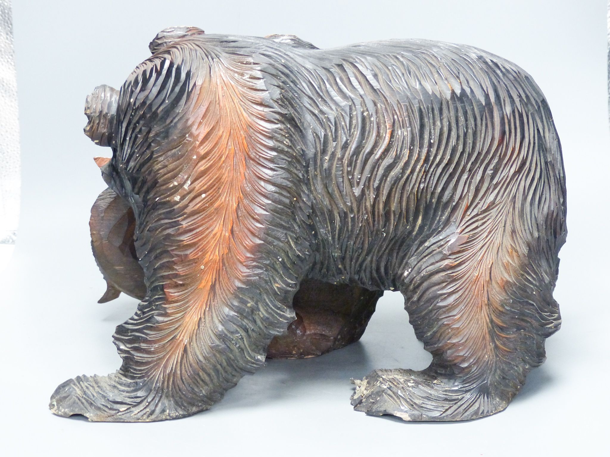 A large carved wood group of a bear and a fish 40cm